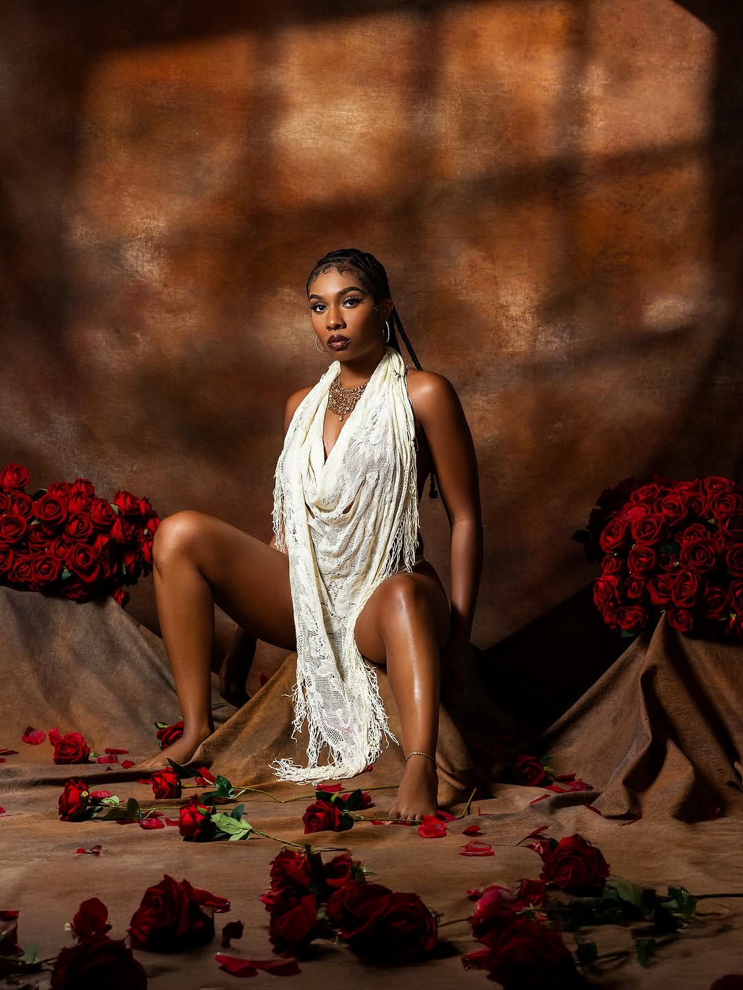 Editorial portrait of Ashliee Moore surrounded by red roses
